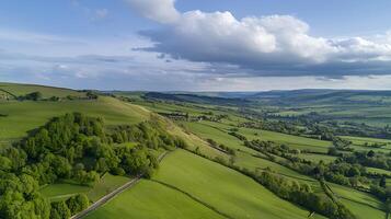 Aerial View of Rolling Green Hills and Farmland Under a Cloudy Sky. photo