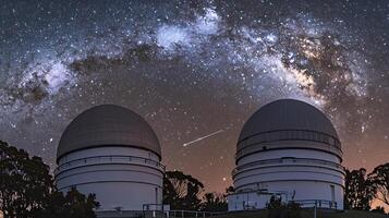 Twin Observatories under a Starry Night Sky with the Milky Way. A breathtaking night scene featuring astronomical research facilities and celestial wonders. photo
