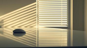 Sunlit Office Desk with Computer Mouse and Venetian Blinds. A minimalist image depicting a reflective surface reflecting sunlight streaming through blinds. photo