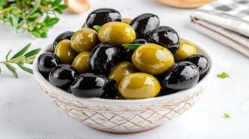 Bowl of Green and Black Olives Ready to Serve. A close up view of a delicious mix of marinated olives in a rustic bowl. photo