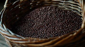 Close up of Dark Brown Seeds in a Wicker Basket. A detailed image of a basket full of small, dark brown seeds. photo