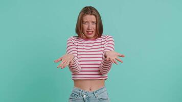 What Why. Sincere irritated young woman raising hands in indignant expression, ask reason of failure demonstrating disbelief irritation by trouble. Pretty confused girl in crop top on blue background video