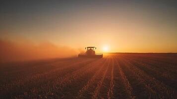 Harvesting at Sunset A Silhouetted Combine in a Golden Field. photo