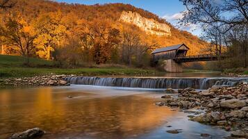 Autumnal Serenity Covered Bridge and Waterfall in a Golden Forest. photo