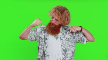 I am the best, choose me. Young happy man feeling very proud pointing herself, looking self-confident, overjoyed by success, making choice. Redhead adult guy isolated on green chroma key background video
