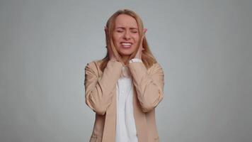 Dont want to hear and listen. Frustrated annoyed irritated office woman covering ears gesturing No, avoiding advice ignoring unpleasant noise loud voices. Tired business girl alone on gray background video