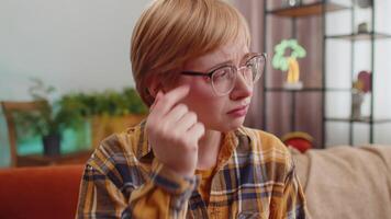 Upset disappointed young woman wipes tears and cries from despair, being sad because of unfair situation, unrequited love. Problem, break up, depressed feeling bad annoyed, burnout. Girl at home room video