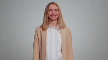 Lovely cheerful business woman greatly approves your suggestion, shaking head approvely, satisfied with good quality work, like proposal. Female girl in formal suit isolated on gray studio background video
