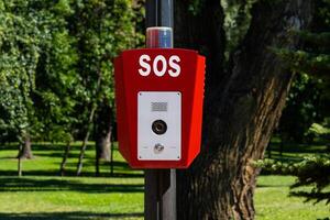 SOS, police, emergency button in the public park photo