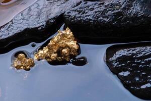 Pure gold ore found in mines with natural water sources . photo