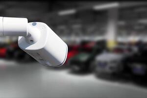 CCTV Camera Operating in car park building. Copy space. photo