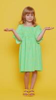 What. Why. Blonde school girl raising hands in indignant expression, asking why, what reason of failure demonstrating disbelief irritation by troubles. Preteen child kid on yellow background. Vertical video