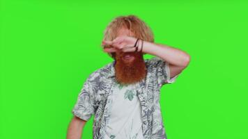 Happy smiling man listening music and dancing disco fooling around having fun expressive gesticulating hands relaxing on party making funny moves. Redhead bearded guy isolated on chroma key background video