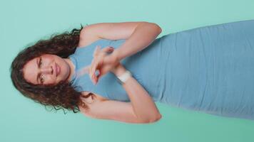 Young woman say No hold palm folded crossed hands in stop gesture, warning of finish, prohibited access, declining communication, body language, danger. Girl on blue background. Lifestyles. Vertical video