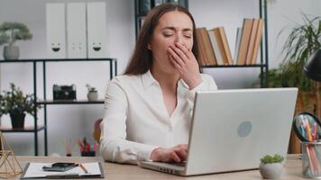 Inefficient tired business woman working sleeping on laptop computer with eyes stickers on face at office workplace desk. Caucasian lazy manager freelancer girl. Business people cheating to sleep video