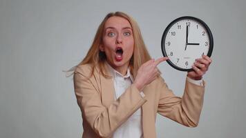 Portrait of young business woman with anxiety checking time on clock, running late to work, being in delay, deadline. Female girl in formal suit looking at hour, minutes, worrying to be punctual video