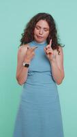 Young Caucasian woman tired bored indifferent expression, exhausted of tedious story not interested in communication talk, displeasure, uninteresting. Girl isolated on blue studio background. Vertical video
