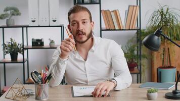 POV of middle eastern businessman working on laptop at office desk, talking online communication call with employee, boss, teacher. Freelancer man support services looking at camera. Webcam view video