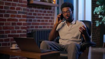 African American business man call mobile phone entrepreneur businessman overtime in night office smiling guy employer talk smartphone friendly male consulting client cellphone chatting cell talking video