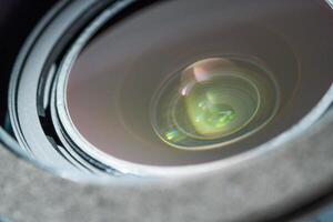 Close up beautiful camera lens with colorful background reflection. photo