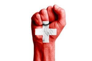 Man hand fist of SWITZERLAND flag painted. Close-up. photo