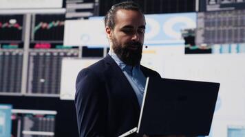 Male public speaker and business coach leading a dynamic presentation with a live audience. Sharing strategy, growth ideas and financial forecasting in a tech driven business event. Camera A. video