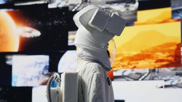 Young male cosmonaut drifting in zero gravity during a space walk, reflecting interstellar adventure, celestial wonder and the future of astronautics and planetary discovery. Space craft. Camera A. video