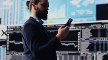 Male entrepreneur taking a phone call to share insight on KPI metrics and evaluate company performance. Specialist using remote communication to improve his profitability, greatness. Camera A. video