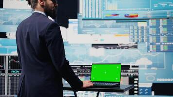General director with a chroma key display reviewing performance metrics, finance graphs and strategy tools to guide a new investment and decision making. Long term business growth. Camera B. video