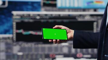 Executive manager with copy space display looks at performance metrics, finance graphs and strategy tools to guide a new investment and decision making. Long term business growth. Camera A. video