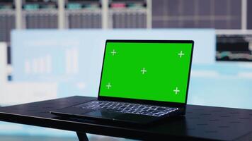Isolated copy space screen running on laptop next to fintech annual reports, strategy for corporate success. Showcasing trends and infographics performance metrics to improve activity. Camera A. video