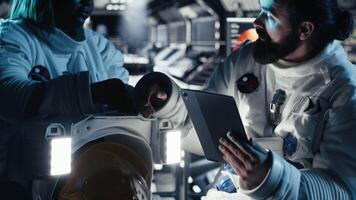 Researchers in starship discussing mission plan during mankind survival expedition. Astronauts doing human expansion in space mission in spacecraft, advancing scientific knowledge, camera B video