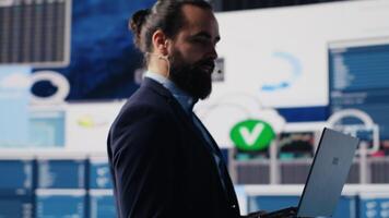 Visionary business leader gives detailed business pitch using data and graphs in a packed public speaking event. Audience listening as the CEO expert shares growth and success insight. Camera A. video