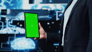 Professional man ensures artificial intelligence algorithms with mockup screen, working with AI brain system for deep learning. Looks at neural networks data processing. Camera A. video