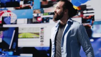 Determined guy admires social media visuals and user interface elements highlighting the power of communication and influence. Modern user experience and web design, self belief. Camera A. video