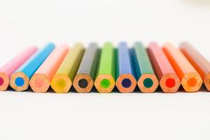 A vibrant collection of colored pencils arranged neatly on a white surface, vibrant hues photo