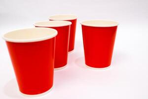 Vibrant Red Paper Cups Arranged on White Background Ready for Refreshments photo