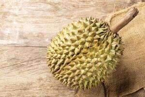 Organic sweet durian fruit, Asian fruit, arranged on a wooden table, top view photo