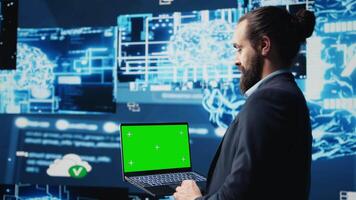 Professional man ensures artificial intelligence algorithms with mockup screen, working with AI brain system for deep learning. Looks at neural networks data processing. Camera B. video