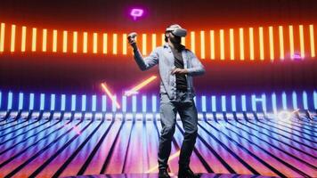 Modern man in a neon lit night scene using VR high tech glasses, embodying cyberpunk style and digital inspiration through artistic vision. Glowing reflections of futuristic aesthetics. Camera B. video
