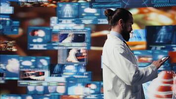 Medical specialist reviewing digital diagnostics and electronic records, symbolizing integration of health tech, personalized patient care and a future in medical science. Breakthrough. Camera B. video