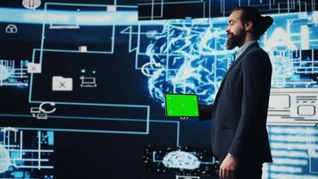 Surrounded by modern AI brain animation, entrepreneur explores virtual intelligence with green screen on device. Using automation platforms for a new innovative IT strategy. Camera B. video