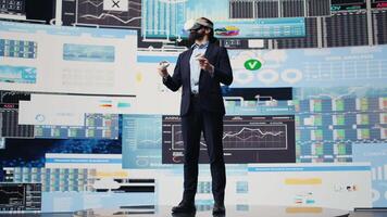 Administrator uses VR glasses to analyze digital graphs and business insight, improving new strategy models for successful development decisions. Optimizing performance with fintech. Camera B. video