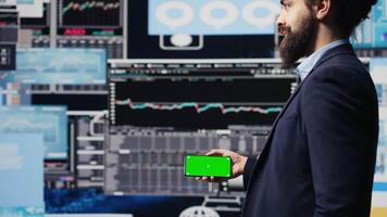 Executive manager with copy space display looks at performance metrics, finance graphs and strategy tools to guide a new investment and decision making. Long term business growth. Camera B. video