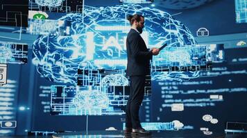 Tech savvy administrator reviewing AI brain programming on a tablet, exploring algorithmic thinking and deep learning through neural networks system. Artificial intelligence coding. Camera B. video