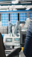 Vertical African american inspectors supervisors engaging in briefing over production metrics, supporting industrial innovation and sustainable process improvement. Solar power manufacturing plant. Camera A. video