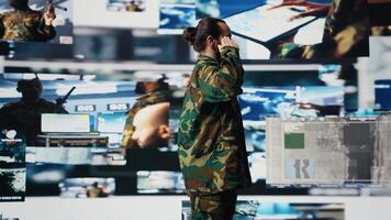 Army officer executes the respectful military salute in command center, collecting crucial information for war planning tactics with battlefield details. High tech army environment. Camera A. video