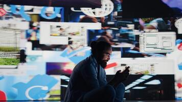 Stressed individual obsessively overuses his mobile phone social apps, illustrating the mental health crisis driven by addiction and excessive information. Cyberbullying and manipulation. Camera B. video