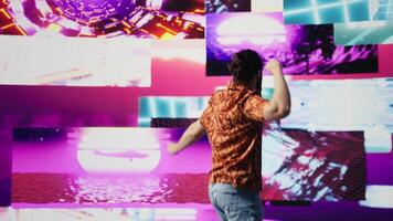 Cool digital content creator dancing under glowing neon lights, expressing rhythm and individuality. Surrounded by groovy music and artistic visuals, bringing energy and retro style. Camera B. video