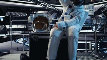 Astronaut taking selfie pictures with smartphone, making hand gestures during planet colonization mission. Orbit station crew member doing photographs with mobile phone during cosmic journey, camera A video